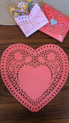 two heart shaped doily sitting on top of a wooden table