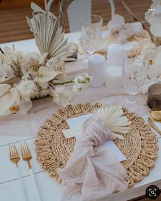 the table is set with white flowers and napkins