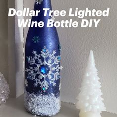 a bottle that has snowflakes on it with the words dollar tree lighted wine bottle diy