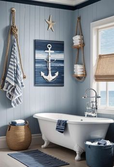 the bathroom is decorated in blue and white with an anchor painting on the wall above the bathtub