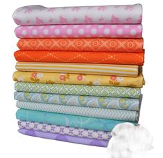 a stack of different colored fabrics on top of each other in various sizes and colors