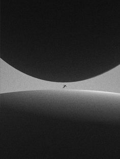 a black and white photo of a person walking in the desert