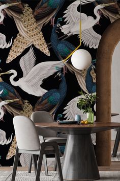 a dining room table with chairs and a wallpaper design featuring white birds in flight