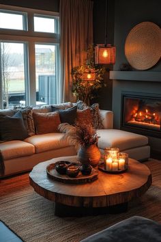 a living room filled with furniture and a fire place in front of a large window