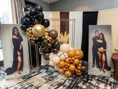 balloons and photos are on display in front of a table with black and gold decorations