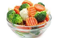 broccoli, cauliflower and carrots in a bowl on a white background