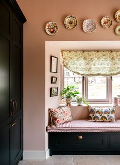 A window seat with floral cushions in a bespoke Wiltshire cottage kitchen design Window Seat Interior Design, Kitchen Table Window Seat, Cottage Window Seat, Kitchen Window Bench Seat, Window Seat Curtain Ideas, Window Seat In Kitchen, Window Seats Ideas, Kitchen Window Seat, Small Window Seat