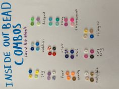 several different colored buttons sitting on top of a sheet of paper