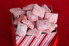 a red and white striped box filled with sugar cubes on top of a table