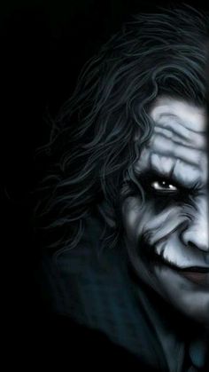 the joker as seen from behind bars with his face painted black and white, in front of a dark background