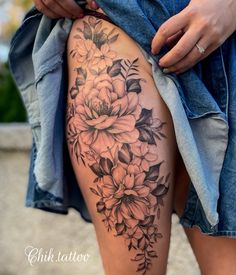 a woman's thigh with flowers on it