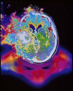 a woman's head with colorful paint splattered on it