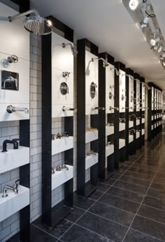 a row of urinals sitting next to each other on the wall in a bathroom