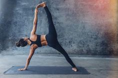 a woman is doing yoga on a mat