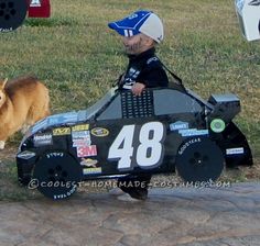 a small child in a race car with a dog