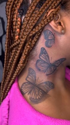 a woman with butterfly tattoos on her neck