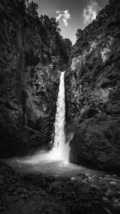 a black and white photo of a waterfall