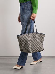 Gucci's tote is spacious, versatile and timeless, making it the perfect everyday style. Crafted in Italy from canvas-jacquard, it's woven with the house's iconic 'GG' monogram and has leather trims including an interior zipped pouch for small essentials. You can even flip it inside out to display the webbing-inspired stripes along the top. Stow your laptop, water bottle and spare pair of flats inside. Modern Gucci Tote Bag, Gucci Coated Canvas Tote Bag, Luxury Gucci Coated Canvas Bag, High-end Gucci Tote Bag, Gucci Tote Shoulder Bag With Gold-tone Hardware, Louise Roe, Eyewear Shop, Gucci Tote, Sunglasses Shop