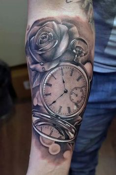 a man with a clock and roses tattoo on his arm