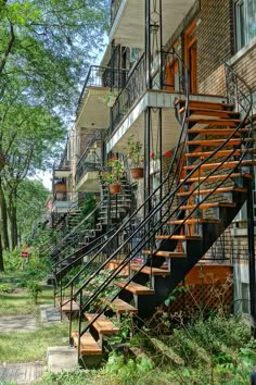 an apartment building with stairs leading up to the second floor