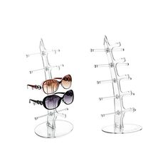 three pairs of sunglasses are on display in the shape of an eyeglass holder,