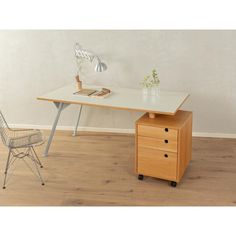 an office desk with two drawers and a chair in front of it on a hard wood floor