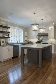 a large kitchen with an island in the middle