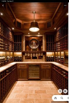 a wine cellar filled with lots of bottles and wooden shelves on either side of the room