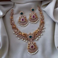 Gold-Plated CZ Necklace Set with Pearls | Luxurious Cubic Zirconia Necklace Set | Elegant Indian Bridal Jewelry | Gold and Pearl Necklace Set | South Asian Wedding Accessories | Traditional Indian Necklace Set | Pearl-Embellished Jewelry | Gold Plated Necklace with CZ Stones | Ethnic Jewelry for Festive Occasions | Timeless Indian Necklace Set | Sophisticated Gold and Pearl Jewelry | Bridal Necklace with Cubic Zirconia | Classic Indian Jewelry for Weddings | Gold-Plated Necklace with Pearls and CZ Stones | Green Necklace Set, Simplistic Jewelry, Aqua Bag, Temple Necklace, Necklace Traditional, Traditional Necklace, American Diamond Necklaces, South Indian Jewelry, Cz Necklace