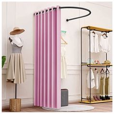 a pink curtain is hanging on the wall next to a rack with clothes and shoes