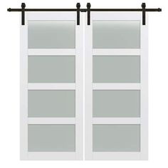 two white sliding doors with black hardware on each side and glass panels at the top