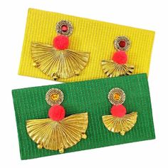 two pairs of yellow and green earrings with red pom - poms on them