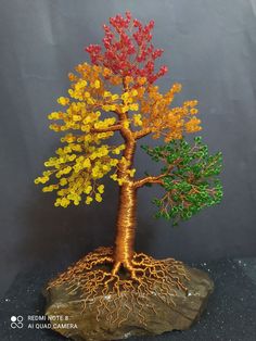 the tree is made out of wire and has colorful leaves