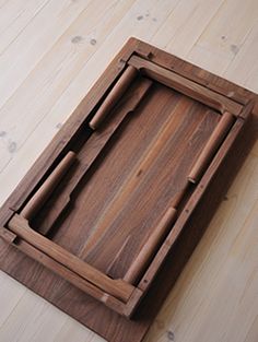 a wooden tray sitting on top of a hard wood floor