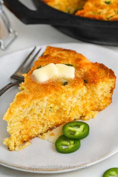 a piece of cornbread casserole on a plate with green peppers