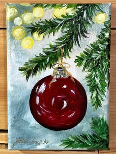 a painting of a christmas ornament hanging from a tree