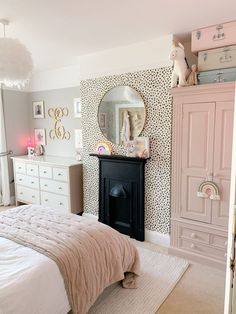 a bedroom decorated in pink and white with a cheetah print wallpaper on the walls