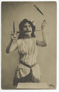 an old photo of a woman with scissors in her hair and holding a knife above her head