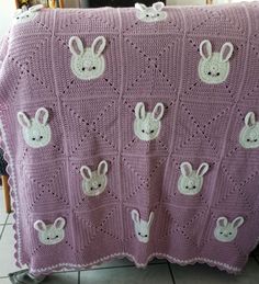 a crocheted blanket with rabbits on it