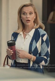 a woman holding a coffee cup and looking surprised