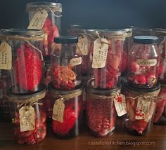 several jars filled with different types of red fruits and vegetables, labeled with chinese characters