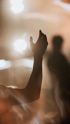 silhouettes of people in front of a stage with lights