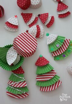 christmas tree cupcakes made out of paper and decorated with red, white and green stripes