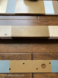 a close up of some wood planks with holes in the middle and two different colors on them