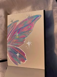 a card with a butterfly painted on it's back and the inside of its wings