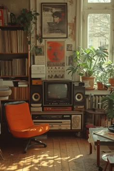 an orange chair sitting in front of a tv on top of a hard wood floor