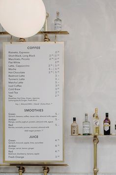 there is a menu on the wall next to some liquor bottles and a light fixture