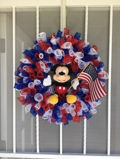 a mickey mouse wreath with an american flag on it