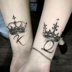 two people with matching tattoos on their arms holding hands, one has a crown and the other has a cross