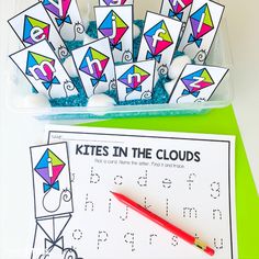 the kites in the clouds worksheet is next to a plastic container filled with letters and numbers